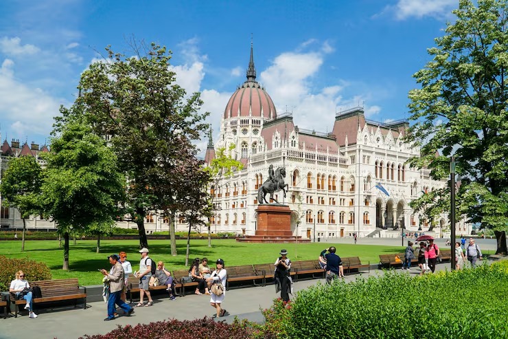 Students and visitors near the Hungarian Parliament building in Budapest
